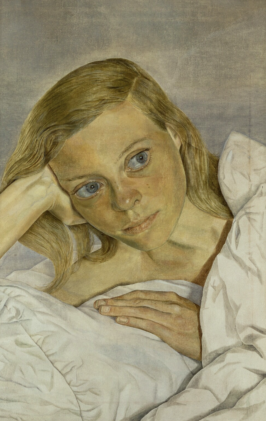 A portrait of a young blonde woman in bed