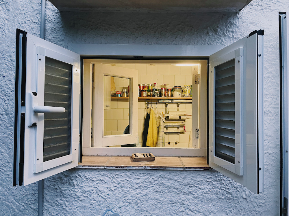 A window looking into a kitchen