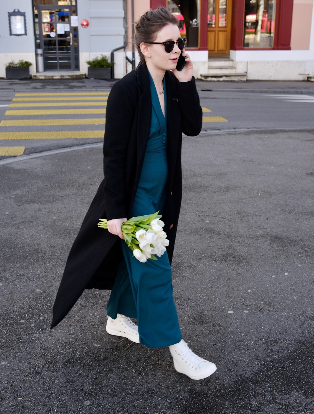 A woman with a bouquet in her hand and a phone to her ear