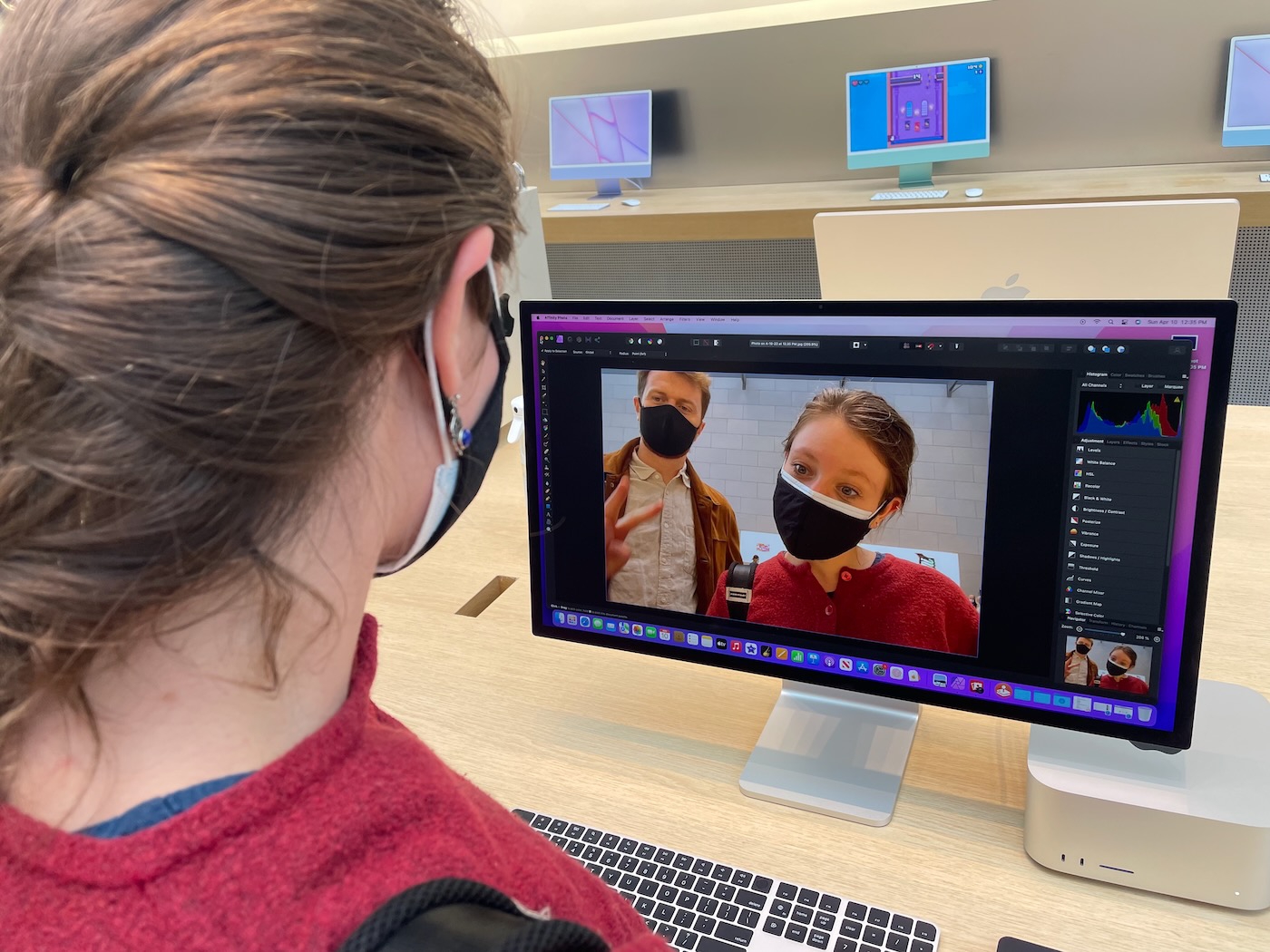 A man and woman taking a selfie in an iMac