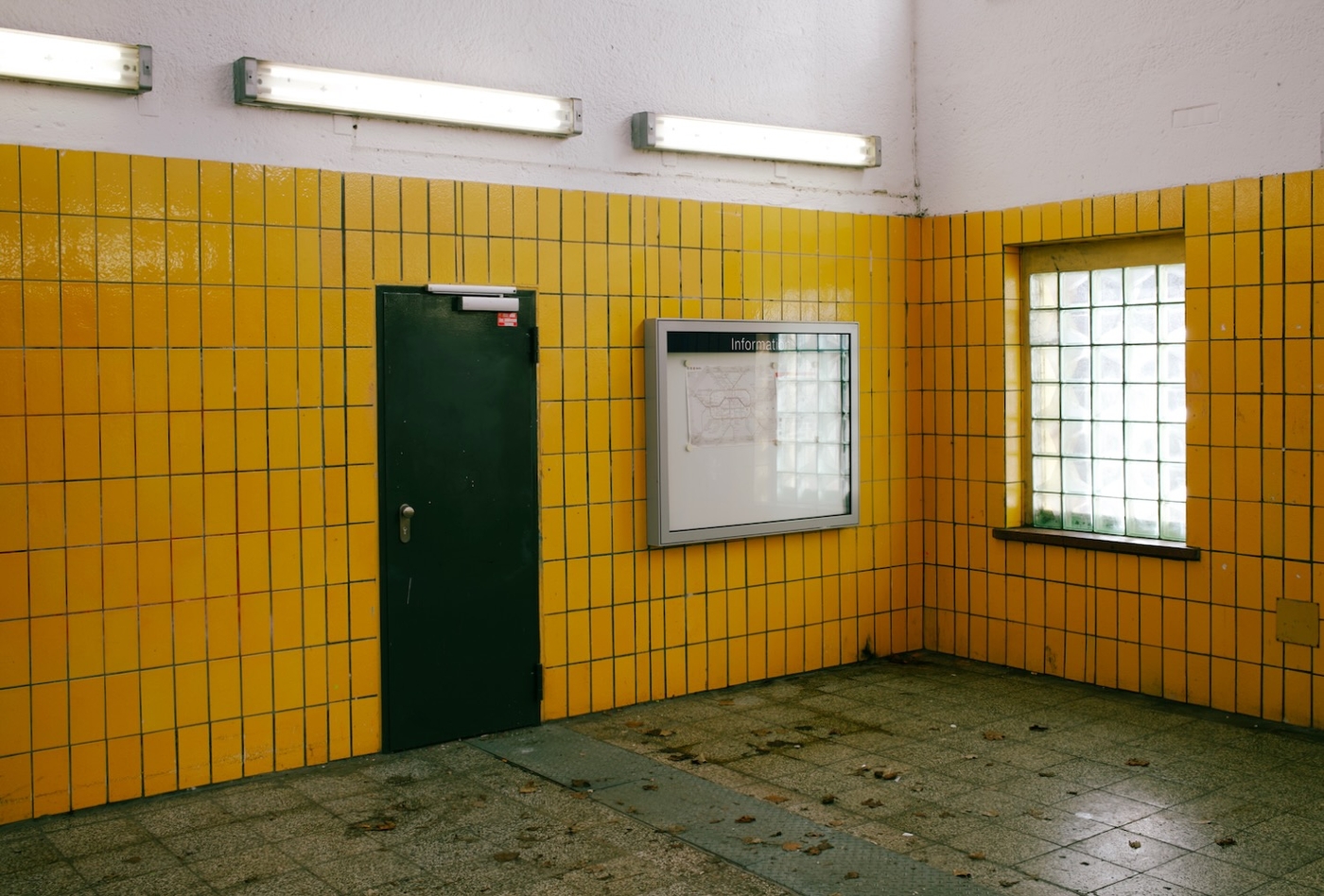 A yellow tiled metro station interior