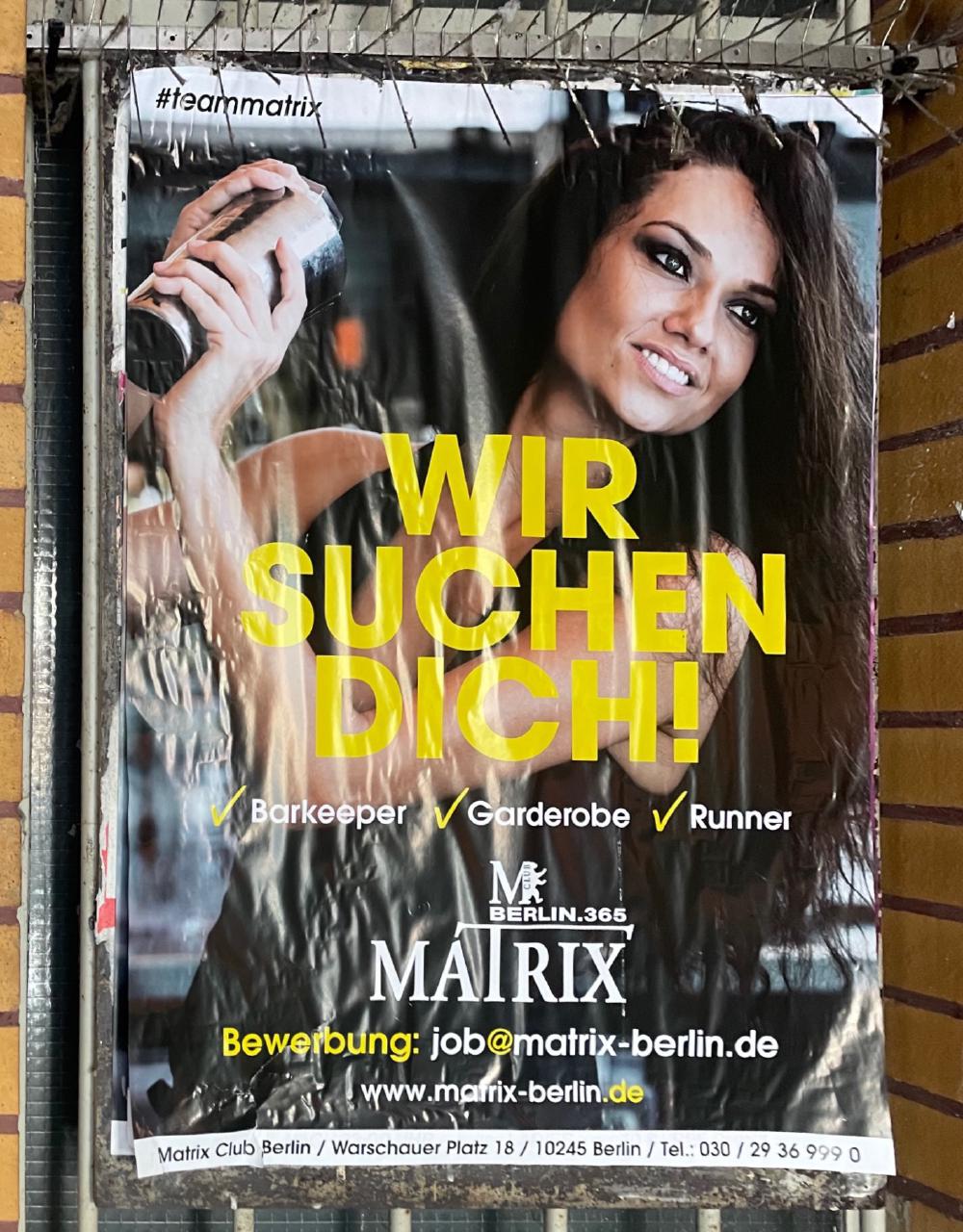 A poster with a young woman and the lettering Wir Suchen Dich