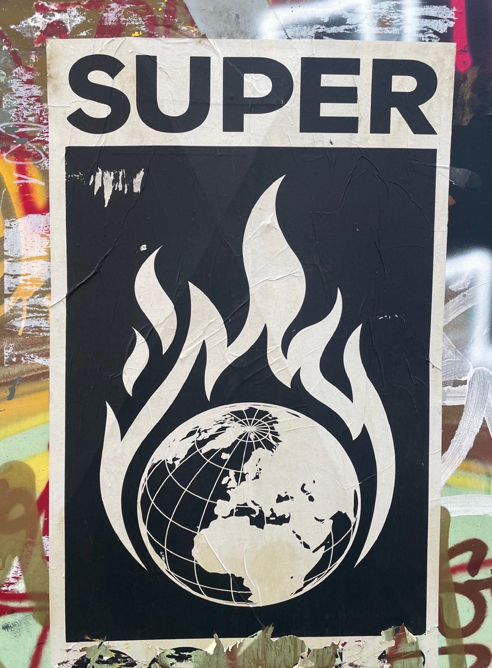 A burning globe motif, title Super