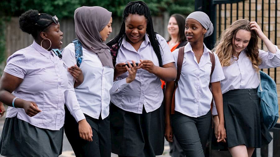 A group of schoolgirls laughing together